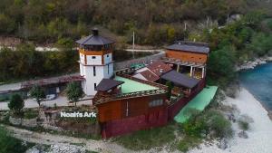 an aerial view of a lighthouse on a beach at Dzajicaa Buk Rooms - Noahs Ark in Konjic