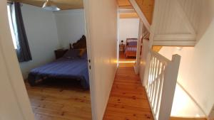 una camera con letto e una scala che conduce a una stanza di Meublé de tourisme au cœur du village à Aramits , haut Béarn ad Aramits