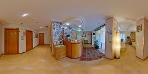 a large room with a hallway with a store at Hostal Restaurante Boccalino in León