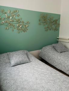 a bedroom with two beds and a painting on the wall at MGG - Apartamento Muelle in Albacete