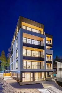 a large building with many windows at night at ROKA by Hakuba Hotel Group in Hakuba