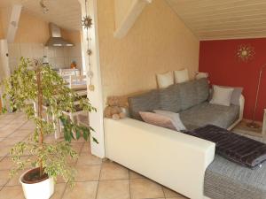 a living room with a couch and a teddy bear at Ferienwohnung am Zeitenweg in Windeck +19 photos