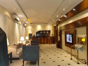a living room with a couch and a television at Nawara Al Askary - Al Sulimaniah in Riyadh