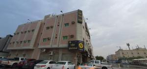 a large building with cars parked in front of it at Nawara Al Askary - Al Sulimaniah in Riyadh