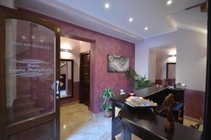 a hotel lobby with a desk and a door at Baia Santa Margherita B&B in Castelluzzo