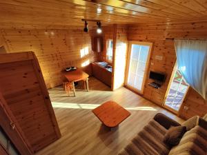 a living room of a log cabin with a couch and a table at Morena in Rusinowo