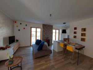 a living room with a couch and a table at La bougainville - luxury apartment in Nago-Torbole