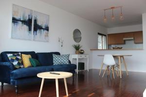 a living room with a blue couch and a table at D Apartment - your home with breathtaking Views in Funchal