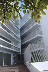 an apartment building with white balconies and trees at D Apartment - your home with breathtaking Views in Funchal +13 photos