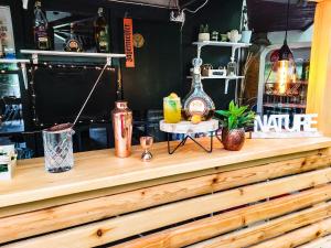 a wooden counter with drinks on top of it at Camping Ursulet Durau in Ceahlău