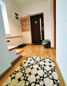 a room with a black and white rug in front of a door at Domek320 in Gronków