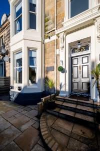 a front door of a building with potted plants at Casa Fresa - Orchar Suites in Dundee