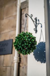 a christmas ornament hanging on the side of a building at Casa Fresa - Orchar Suites in Dundee +54 photos