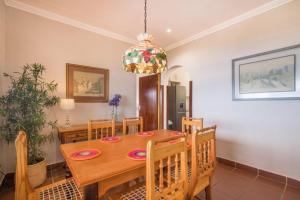 a dining room with a wooden table and chairs at Victoria Bay Holiday Cottage in George
