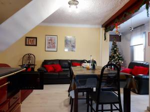 a living room with a table and a christmas tree at Apartman Anika in Moravice