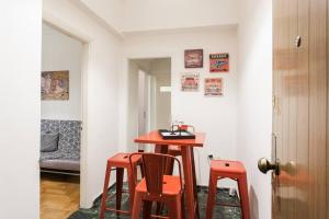 a small table and two stools in a room at Downtown Athens-Plaka Skoufou Apt/VaccinatedHost in Athens