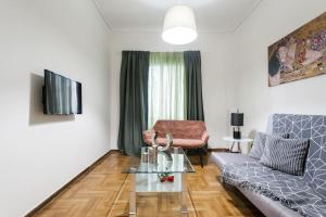 a living room with a couch and a table at Downtown Athens-Plaka Skoufou Apt/VaccinatedHost in Athens