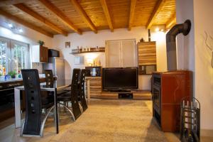a kitchen and dining room with a table and a television at Skarb Bałtyku Dom in Debina