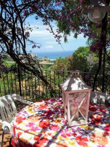 a table with a lantern sitting on top of it at Residenza Crivo in Parghelia