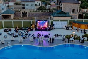 an overhead view of a large event with a projection screen at Khazar Inji in Baku