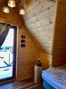 a room with a wooden wall with a window at Little House in Ząb