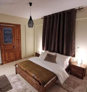 a bedroom with a large bed with a large window at KERAMIDAKI MINI SUITES 4 in Kalavrita