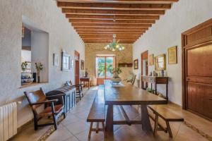 a dining room with a wooden table and chairs at Cadell Gran in Sa Pobla