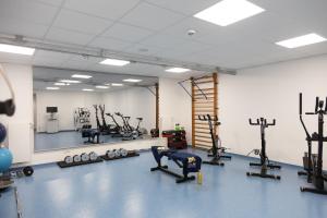 a gym with bikes and exercise equipment in a room at Sporthotel TREFF PUNKT in Wiesbaden