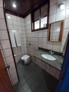 a bathroom with a sink and a toilet at Pousada Mucugê in Mucugê