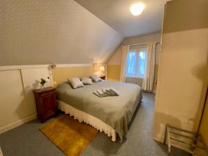 a bedroom with a bed with two pillows on it at Hôtel de famille L.F.M.A.L. in Giat