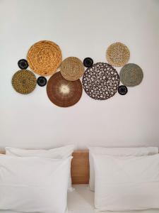 a wall with several different types of bowls on it at Aelia Rooms & Apartments in Ios Chora