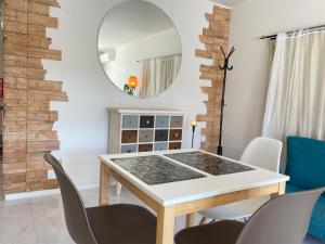 a dining room with a table and chairs and a mirror at Kamakura Jomyoji Terrace in Kamakura