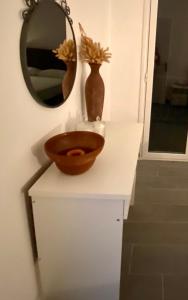 a bathroom with a bowl on a counter with a mirror at Casa di Vittorio in Kanoni