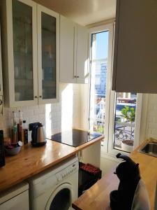 a kitchen with a stove top oven next to a window at Anna's Home Sweet Home in Boulogne-Billancourt