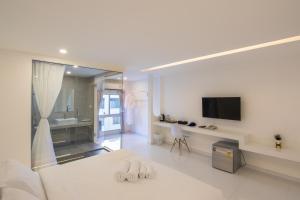 A television and/or entertainment centre at Thewhitehotel BY Charoensri - SHA Extra Plus
