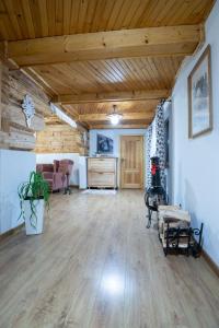 a large living room with wooden ceilings and wooden floors at Chata Litwor in Bukowina Tatrzańska