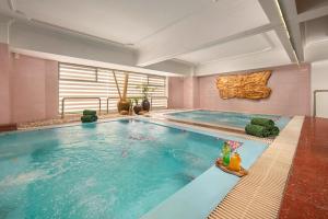 a large swimming pool in a room with at The Tray Hotel Hai Phong in Hai Phong
