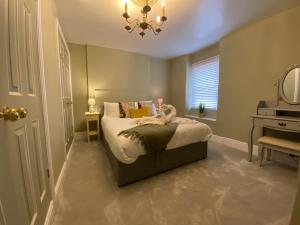 a small bedroom with a bed and a mirror at Chapel Cottage Idylic Village Holiday Home in Box