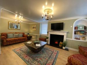 a living room with a couch and a fireplace at Chapel Cottage Idylic Village Holiday Home in Box