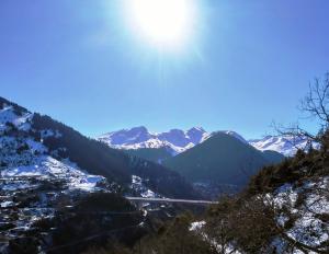 a view of a valley with snow covered mountains at Baou House in Metsovo