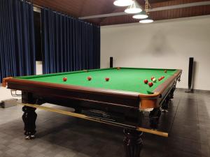 a pool table with balls on top of it at Heaven Valley Resorts Vagamon in Vagamon