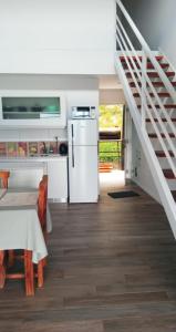 a kitchen with a white refrigerator and a staircase at Aparahik in Ushuaia