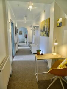 a hallway with a table and a desk in a room at 'Harbour View' on the river by Gorleston's award winning beach - Pet free! in Gorleston-on-Sea