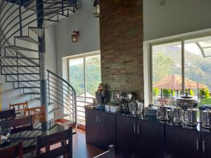 a kitchen with a staircase and a counter with pots and pans at Heaven Valley Resorts Vagamon in Vagamon