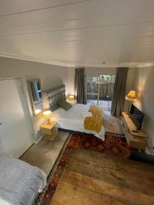 a bedroom with a bed and a television in it at Sarah's Place- Heatherlands,George in George +177 photos