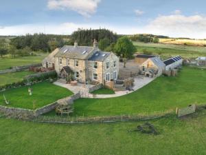 an aerial view of a large house in a field at Meagill farmhouse hot tub bbq hut in Otley