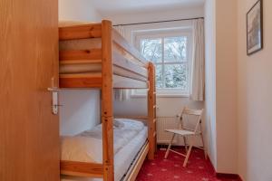 a bunk bed in a small room with a window at Kitz Residenz Eleven by All in One Apartments in Kaprun