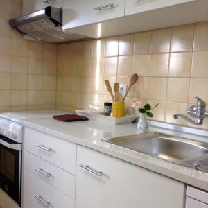 a kitchen with a sink and a counter top at myninho in Vila Nova de Gaia