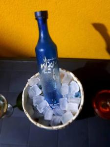 a bottle of water in a bowl filled with ice cubes at Cozy 1-bedroom in a secure area with private beach in Mammee Bay