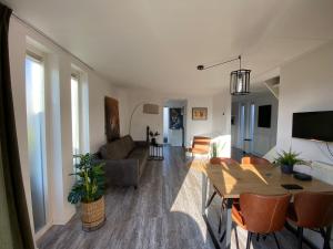a living room with a table and a couch at Vakantiewoning Zwinstraat Zoutelande in Zoutelande